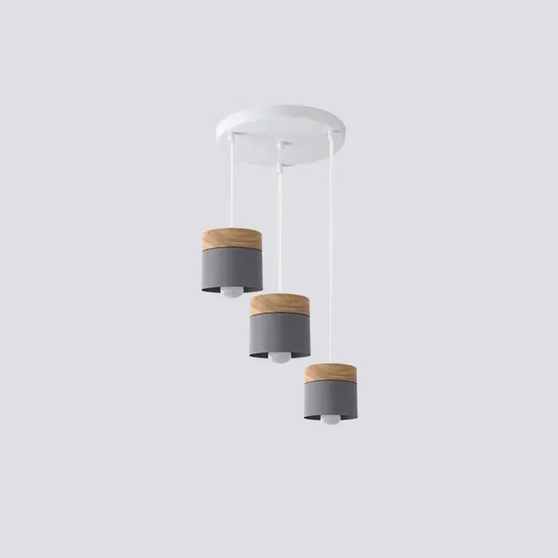Lampadario cilindrico con base in legno dal design nordico per la sala da pranzo