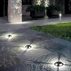 Segnapasso calpestabile esterno LED rotondo nero moderno con effetto luminoso