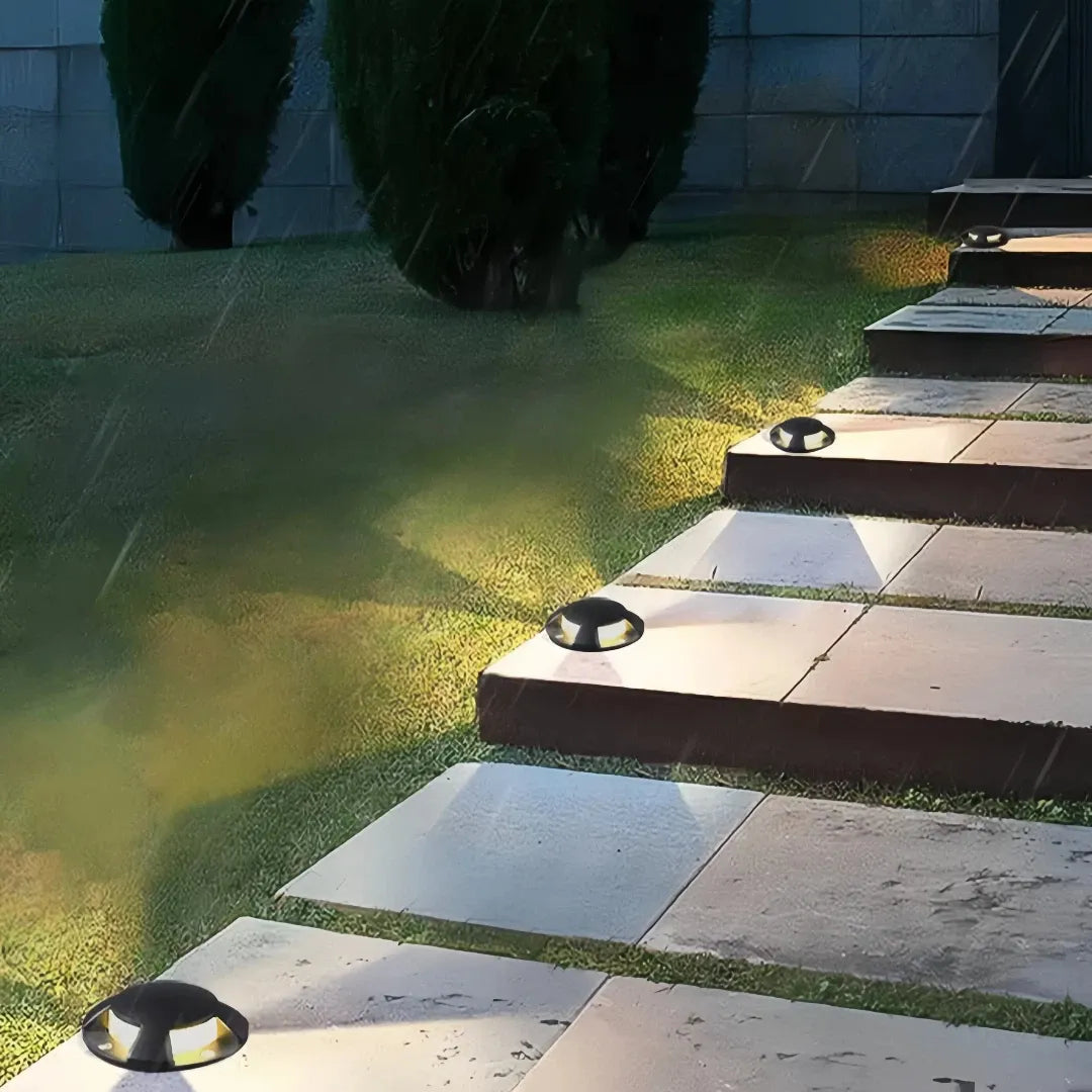 Segnapasso calpestabile esterno LED rotondo nero moderno con effetto luminoso
