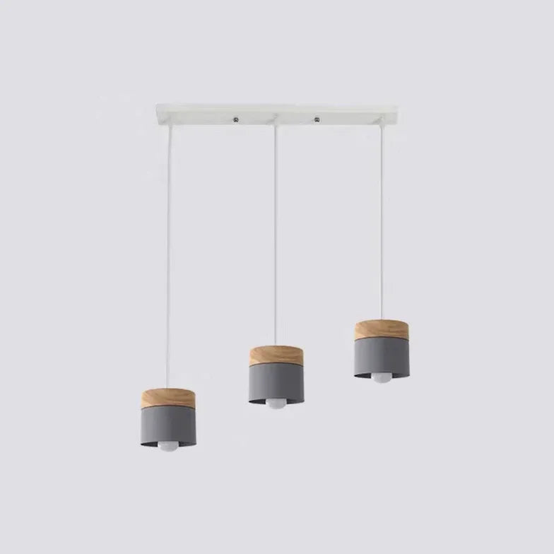 Lampadario cilindrico con base in legno dal design nordico per la sala da pranzo